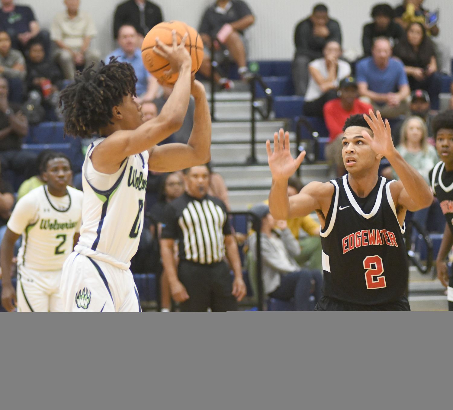 Windermere's Ta'Veon Jones goes for a 3-pointer against Edgewater's Erik Taylor during the first half Wednesday. Jones scored a game-high 26 points in the Wolverines' 83-75 victory. Taylor had 14 points.